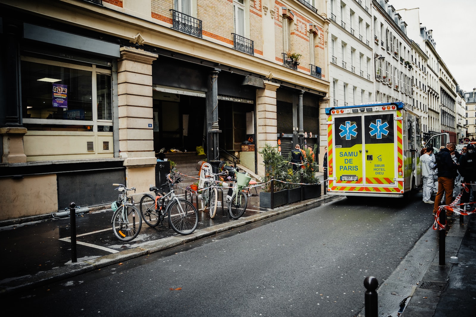 a bus parked on the side of a street next to tall buildings